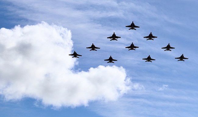 Jet aircraft from VFA-2 Bounty Hunters fly in formation over NAS Lemoore before landing after a long four-month deployment. 